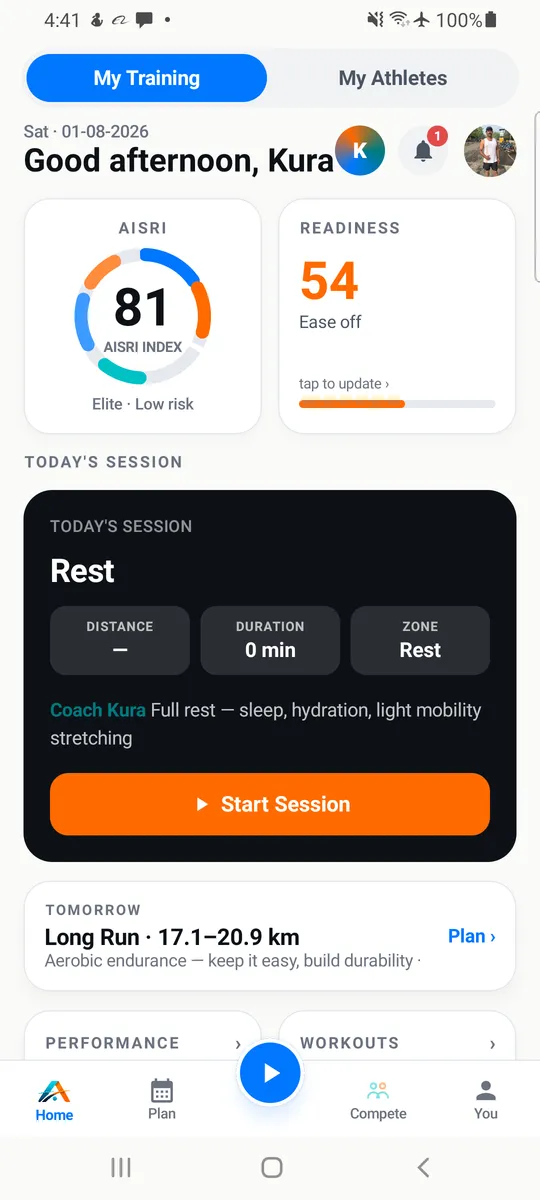 The AKURA app’s Today screen from Coach Kura’s own account: the AISRI Index ring, readiness saying “ease off”, today’s session set to rest with a note from Coach Kura, and tomorrow’s long run.